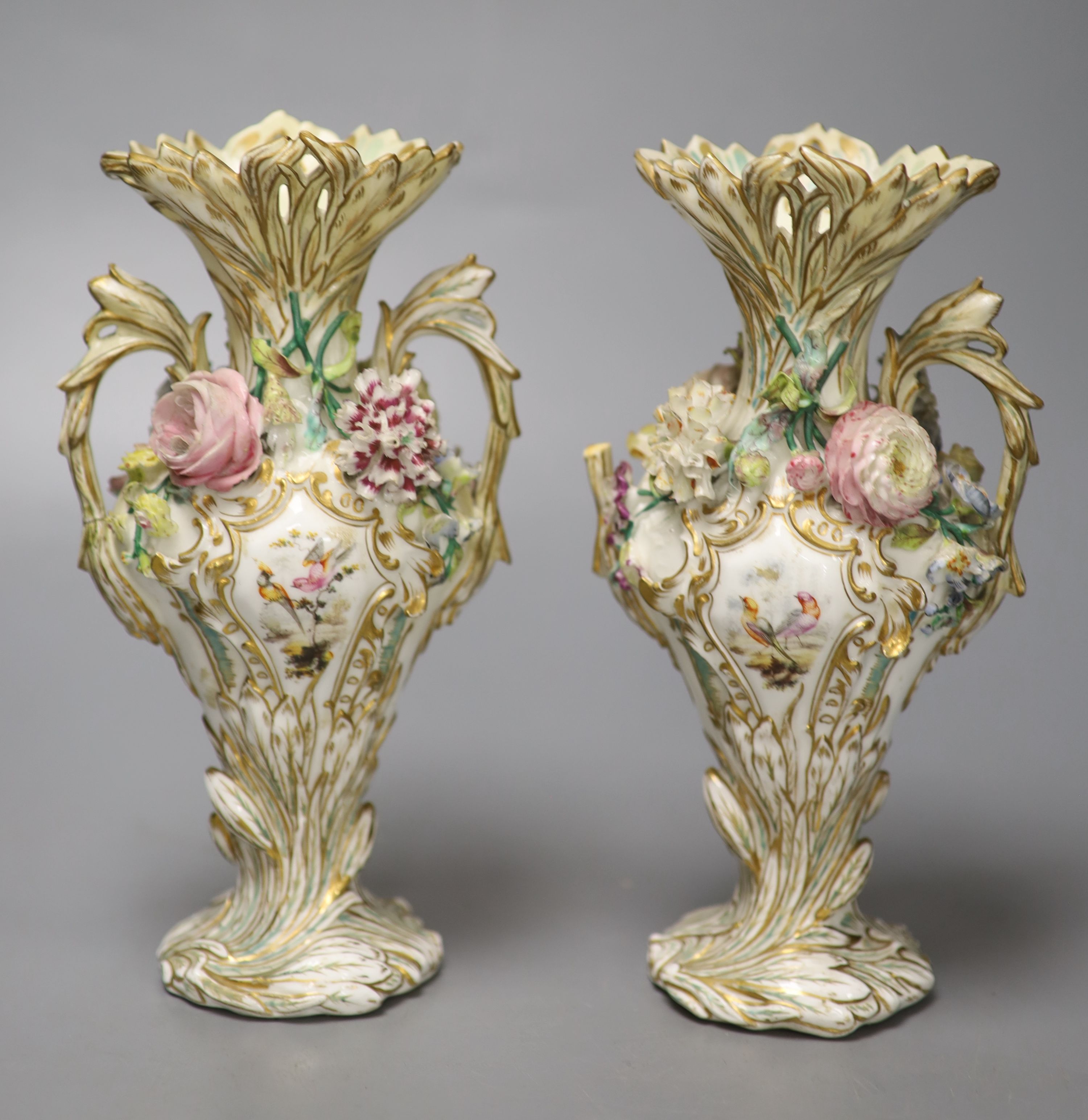 An English porcelain two handled green ground vase and a pair of floral encrusted vases, 20cm